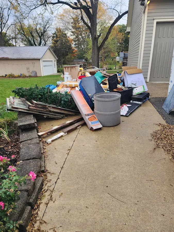 Dumpster being loaded with debris for Estate Cleanout Dumpster Rental in Atlantic Highlands